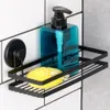 A black metal shower shelf with a blue soap dispenser and a yellow sponge attached to a tiled wall. Podgląd zdjęcia produktu