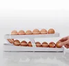 A white egg holder with eggs on a marble countertop. Náhled obrázku produktu
