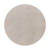 A round, gray rug on a white background. Voir les images du produit
