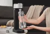 A person is using a Philips soda maker in a home setting. Podgląd zdjęcia produktu