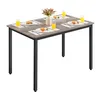 A dining table set for four people with placemats, plates, and glasses of orange juice. Náhled obrázku produktu
