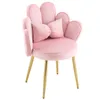 A pink velvet chair with gold legs, shaped like a flower, with a bow-shaped pillow. Náhľad obrázku produktu