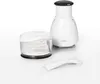 A white manual food chopper and a measuring cup are displayed on a white background. Produktbild-Vorschau