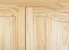 A close-up view of the natural wood grain and decorative molding on two cabinet doors. Produktbild-Vorschau