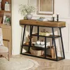 A console table with shelves in a room setting, decorated with books, vases, and candles. Náhled obrázku produktu