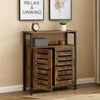 A dark brown wooden cabinet with black metal frame, displayed in a room with framed art on the wall. Produktbild-Vorschau