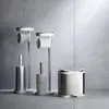 A modern bathroom setting with toilet paper stands and a trash can. Voir les images du produit