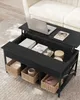 A black lift-top coffee table with storage, set on a rug next to a couch. Náhled obrázku produktu