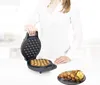 A person is holding open a waffle maker with waffles inside, and a finished waffle with ice cream is on a plate next to it. Produktbild-Vorschau