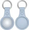 Two light blue silicone cases for Apple AirTags are shown side-by-side against a white background. The case on the left shows the inside with a white circular insert, while the case on the right shows the solid back. Produktbild-Vorschau