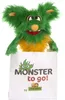 A green and orange furry monster puppet peeking out of a white bag with text and a logo. Náhľad obrázku produktu
