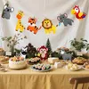 A table set for a party with a cake, sushi, cheese, and animal decorations. Produktbild-Vorschau