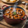 A pot of steaming goulash is presented on a wooden table, with some cheese slices in the background. Produktbild-Vorschau