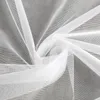 A close-up, draped view of white sheer fabric, likely a curtain or veil, against a neutral gray background. Voir les images du produit