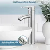 A bathroom sink faucet is shown in a clean, modern bathroom setting, next to a sink and a decorative vase. Produktbild-Vorschau