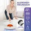 A woman is demonstrating a handheld vacuum cleaner on a mattress, with various icons and text highlighting product features. Produktbild-Vorschau