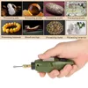 A hand holding a mini electric drill with various materials shown in the background that can be processed by the tool. Náhled obrázku produktu