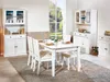 A dining room scene with a white buffet and dining table set for a meal. Produktbild-Vorschau