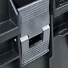 A close-up view of a black plastic tool box latch mechanism. Náhled obrázku produktu