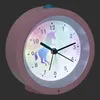A close-up, angled view of a pink analog alarm clock with a unicorn design on its face, set against a dark gray background. Podgląd zdjęcia produktu