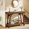A console table with decorative items in a hallway with stairs. Podgląd zdjęcia produktu