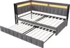 A corner view of a gray upholstered daybed with a pull-out trundle bed underneath. The headboard has integrated LED lighting. Produktbild-Vorschau