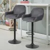 Two dark gray bar stools are shown in a room with a shelf and a table. Voir les images du produit