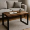 A coffee table with a book and mug on it, placed in front of a sofa. Produktbild-Vorschau