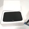 A black TomTom navigation device is placed inside a white box. Voir les images du produit