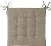 A single square cushion with tufted buttons and ties on a white background. Produktbild-Vorschau