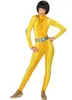 A woman wearing a yellow spy costume with a silver belt. Podgląd zdjęcia produktu