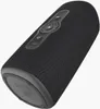 A black cylindrical Bluetooth speaker is shown from a low angle, with its top surface angled towards the viewer. The speaker has a mesh grille covering most of its surface and a control panel on top with buttons and indicator lights. The bottom of the spea Náhľad obrázku produktu