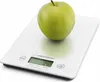 A green apple is placed on a white digital kitchen scale. Náhled obrázku produktu