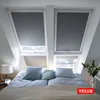 A bedroom with two skylights covered by gray roller blinds. Produktbild-Vorschau