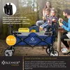 A family is enjoying a picnic outdoors with a KESSER® foldable wagon. Produktbild-Vorschau