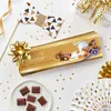 A festive arrangement of Lindt chocolate, party decorations, and confetti. Podgląd zdjęcia produktu