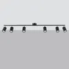 A black track light fixture with six adjustable spotlights is mounted on a light gray background. Podgląd zdjęcia produktu