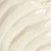 A close-up, textured view of a creamy substance, likely a cosmetic product. Podgląd zdjęcia produktu