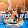 A woman is relaxing in a pool with a floating tray filled with drinks, snacks, and a tablet. Náhled obrázku produktu