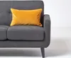 A close-up shot of a grey sofa with a yellow cushion. Produktbild-Vorschau