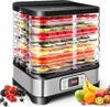A food dehydrator filled with various fruits and vegetables, placed on a surface with a pile of fresh berries and bananas nearby. Voir les images du produit