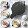 A black electric kettle is shown steaming, surrounded by cups of coffee and tea, a sugar bowl, and a creamer on a marble-like surface. Produktbild-Vorschau