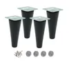 Four black furniture legs with silver mounting plates, screws, and felt pads are arranged on a white background. Podgląd zdjęcia produktu