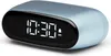 A light blue digital alarm clock is shown against a white background. The clock displays the time 10:30 AM with a small bell icon indicating an alarm is set. Produktbild-Vorschau