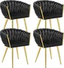 Four black velvet dining chairs with gold legs are arranged in a 2x2 grid against a white background. Voir les images du produit