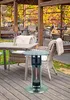 An outdoor patio setting with tables, chairs, and a patio heater. Produktbild-Vorschau