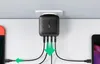 A black UGREEN GaN Tech fast wall charger plugged into a wall outlet, with multiple USB cables connected to two smartphones. Produktbild-Vorschau