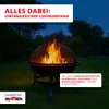 A fire pit with a flame burning inside, set in a garden at dusk. Produktbild-Vorschau