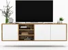 A modern TV stand with white doors and wood accents, featuring a large TV and decorative items. Podgląd zdjęcia produktu