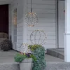 Decorative sphere lights on a porch with plants. Produktbild-Vorschau